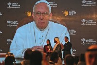 Pope Francis, who spoke of the importance of education and teachers in a video message to the audience, introduces the winner of the second annual Global Teacher Prize, Palestinian primary school teacher Hanan al-Hroub, who receives her trophy from Sheikh Mohammed Bin Rashid Al Maktoum, UAE Vice President and the Ruler of Dubai, center, in Dubai, United Arab Emirates, Sunday, March 13, 2016. Al-Hroub who encourages students to renounce violence won a $1 million prize for teaching excellence. (AP Photo/Kamran Jebreili)