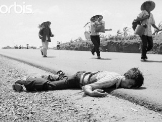 12 Apr 1975, South Vietnam --- Killed While Fleeing. Highway I, S. Vietnam: The search for safer ground continues in South Vietnam where enemy rocket fire caused the death of one of the many who are fleeing their homes in the face of advancing Communist troops. These civilians move down Highway I from Xuan Loc where government and enemy troops are engaged in heavy fighting. --- Image by © Bettmann/CORBIS