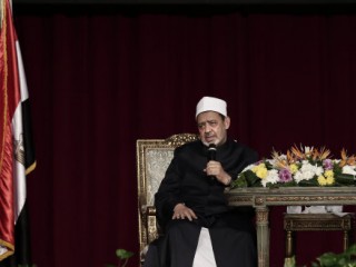 FILE - In this Tuesday, Dec. 1, 2015 file photo, Sheikh Ahmed el-Tayeb, Grand Imam of Al-Azhar, the pre-eminent institute of Islamic learning in the Sunni Muslim world, right, delivers a speech to university students and clerics, calling on youth to combat religous extremism at Cairo University, Egypt,. (AP Photo/Nariman El-Mofty, File)
