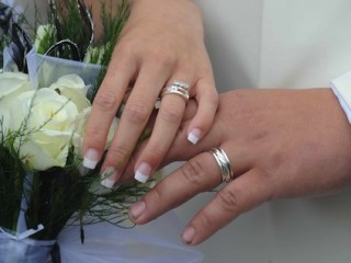 Chris May and Odette Fenwick show their 19 wedding rings at their wedding in Barnstaple.