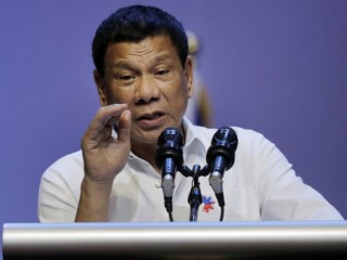 Philippine President Rodrigo Duterte speaks to the Filipino community in Singapore on Friday, Dec. 16, 2016. (AP Photo/Wong Maye-E)