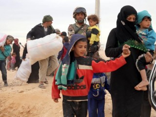 Syrian refugees arrive in early May at a camp on the border in Royashed, Jordan. (CNS photo/Jamal Nasrallah, EPA) See YEAR-END-REFUGEES Dec. 14, 2016.