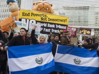 Demonstrators protest against the World Bank's procedures to rule on the Pacific Rim vs. El Salvador lawsuit regarding river water pollution from gold mining, outside the World Bank Headquarters in Washington, DC, March 19, 2015. AFP PHOTO / SAUL LOEB        (Photo credit should read SAUL LOEB/AFP/Getty Images)