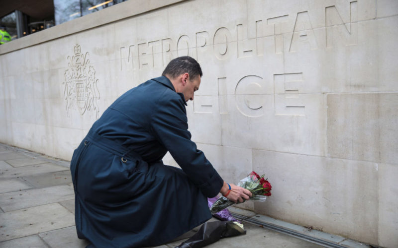 LONDON, ENGLAND - MARCH 23: A man lays flowers outside New Scotland Yard following yesterday's attack in which one police officer was killed on March 23, 2017 in London, England. Four people have been killed and around 40 people injured following yesterday's attack by the Houses of Parliament in Westminster.