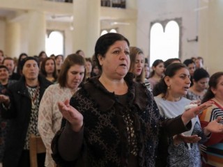 Worshippers pray during Easter Mass April 16 in St. George Chaldean Catholic church in Tel Esqof, Iraq. The church was damaged by Islamic State militants. (CNS photo/Marko Djurica, Reuters)