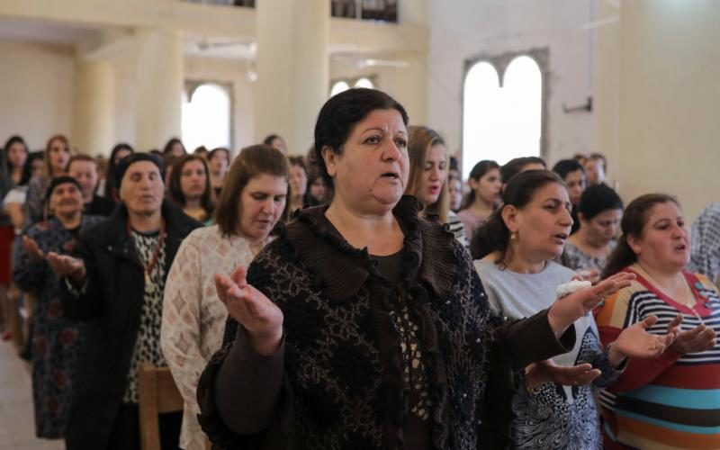 Worshippers pray during Easter Mass April 16 in St. George Chaldean Catholic church in Tel Esqof, Iraq. The church was damaged by Islamic State militants. (CNS photo/Marko Djurica, Reuters)
