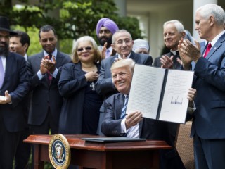 President Donald Trump shows his signed Executive Order on Promoting Free Speech and Religious Liberty during a National Day of Prayer event at the White House in Washington May 4. (CNS photo/Jim Lo Scalzo, EPA) See RELIGIOUS-FREEDOM-EXECUTIVE-ORDER May 4, 2017.