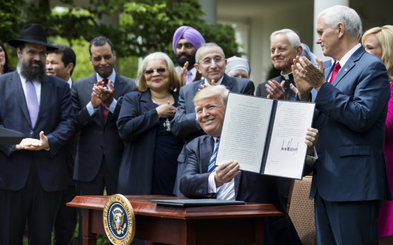 President Donald Trump shows his signed Executive Order on Promoting Free Speech and Religious Liberty during a National Day of Prayer event at the White House in Washington May 4. (CNS photo/Jim Lo Scalzo, EPA) See RELIGIOUS-FREEDOM-EXECUTIVE-ORDER May 4, 2017.