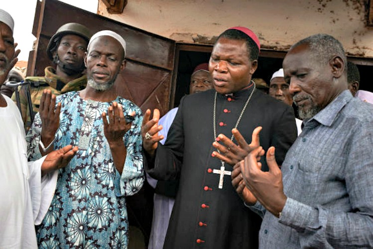 TheArchbishop Dieudonne˙ Nzapalainga  and Imam Omour Kobine of Bangui pray together during a tour to spread the word of tolerance and reconciliation at a mosque in the quartier Kilometre 5 in Bangui, Central African Republic on December 11, 2013. Just earlier at a a church, IDPs staying at the camp realised that a truck with food supplies was delivered by the Muslim community as in an act of goodwill and screamed in the local language song " we would rather die of hunger than eat a gift of food from muslims." Many also screamed that the food was poisoned. On the morning of Thursday 5th, December Christian anti-balika militants entered the city and attacked Seleka rebels. Over the days that followed hundreds of people were killed. The Seleka made up of a muslim majority with many of the rebels originating from northern Central African Republic, Sudan and Chad brought to power a new president Michel Djotodia, a former Seleka leader in a March 24, 2013 coup.  The political establishment has failed to control the armed group that has wreaked havoc, including murdering, looting and burning of villages on the civilian population with mass displacements resulting throughout 2013. A 1600 strong French force deployed to the country is supporting African Union peacekeepers and attempting to disarm the rival Christian and Muslim fighters in the country.