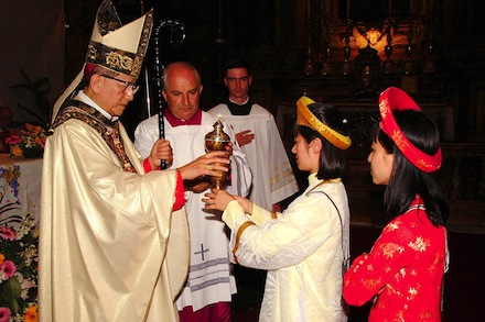 Vietnamese Cardinal Francois Xavier Nguyen Van Thuan receives the eucharistic gifts at a church service in Rome Oct. 14, 2001. The head of the Pontifical Council for Justice and Peace died Sept. 16 in Rome after an extended battle with cancer. He was 74. (CNS photo by Alessia Giuliani, CPP) (Sept. 17, 2002) See OBIT-THUAN Sept. 17, 2002.