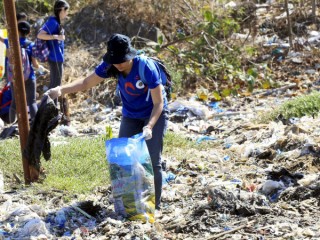 A volunteer picks up trash at Freedom Island, a marshland considered to be a sanctuary for birds, fish and mangroves in a coastal area of Las Pinas City, near Manila, Philippines, April 22. Few papal encyclicals have been as eagerly awaited as Pope Francis' upcoming statement on the environment.  (CNS photo/Romeo Ranoco, Reuters) See ENCYCLICAL-PLANS April 29, 2015.