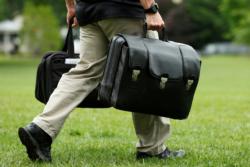 An aide carries a case containing launch codes for nuclear weapons in Washington while following President Donald Trump before his departure to Camp David June 17. (CNS photo/Yuri Gripas, Reuters) See UN-WEAPONS June 30, 2017.