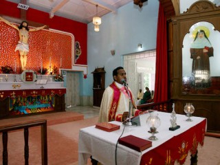 An Indian Catholic Priest delivers his sermon during a special mass at Sister Alphonsa's church in Mala, in the southern Indian state of Kerala on October 11, 2008.  Christians are gearing up to celebrate the canonization by Pope Benedict XVI of the young Roman Catholic nun Alphonsa who once disfigured herself to avoid marriage, some sixty years after her death.  AFP PHOTO/RAVEENDRAN / AFP PHOTO / RAVEENDRAN