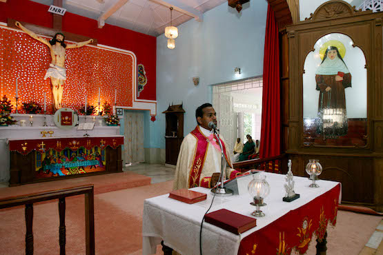 An Indian Catholic Priest delivers his sermon during a special mass at Sister Alphonsa's church in Mala, in the southern Indian state of Kerala on October 11, 2008. Christians are gearing up to celebrate the canonization by Pope Benedict XVI of the young Roman Catholic nun Alphonsa who once disfigured herself to avoid marriage, some sixty years after her death. AFP PHOTO/RAVEENDRAN / AFP PHOTO / RAVEENDRAN