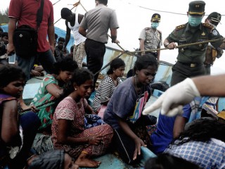 Migrants from Sri Lanka remain on their boat despite their vessel being washed ashore on the west coast of Lhoknga in Aceh Besar, Indonesia's Aceh province on June 14, 2016.
Dozens of Sri Lankan immigrants bound for Australia were stranded off Aceh in northwest Indonesia after their boat broke down, local officials said on June 12. / AFP PHOTO / CHAIDEER MAHYUDDIN