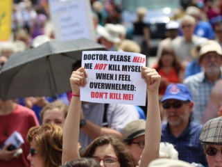 A woman holds up a sign during a rally against assisted suicide in 2016 on Parliament Hill in Ottawa, Ontario. In a Toronto speech, Cardinal Gerhard Muller, prefect of the Congregation for the Doctrine of the Faith, has urged Canadians to work to reverse euthanasia rulings. (CNS photo/Art Babych) See CANADA-MULLER-EUTHANASIA May 17, 2017.