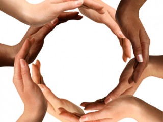 Conceptual symbol of multiracial human hands making a circle on white background with a copy space in the middle