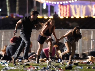 LAS VEGAS, NV - OCTOBER 01:  People run from the Route 91 Harvest country music festival after apparent gun fire was hear on October 1, 2017 in Las Vegas, Nevada. A gunman has opened fire on a music festival in Las Vegas, leaving at least 20 people dead and more than 100 injured. Police have confirmed that one suspect has been shot. The investigation is ongoing. (Photo by David Becker/Getty Images)