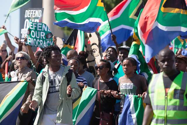 Protesters_march_to_parliament_in_protest_at_President_Jacob_Zuma_Credit_Aqua_Images_Shutterstock_CNA