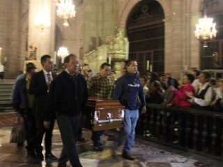 Pallbearers carry the casket of Father Miguel Angel Machorro during his Aug. 3 funeral Mass at the Metropolitan Cathedral in Mexico City. Father Machorro was stabbed at the altar while celebrating Mass May 15. (CNS photo/Cesar Juarez, Archdiocese of Mexico) See MEXICO-CITY-PRIEST-DIED Aug. 3, 2017.