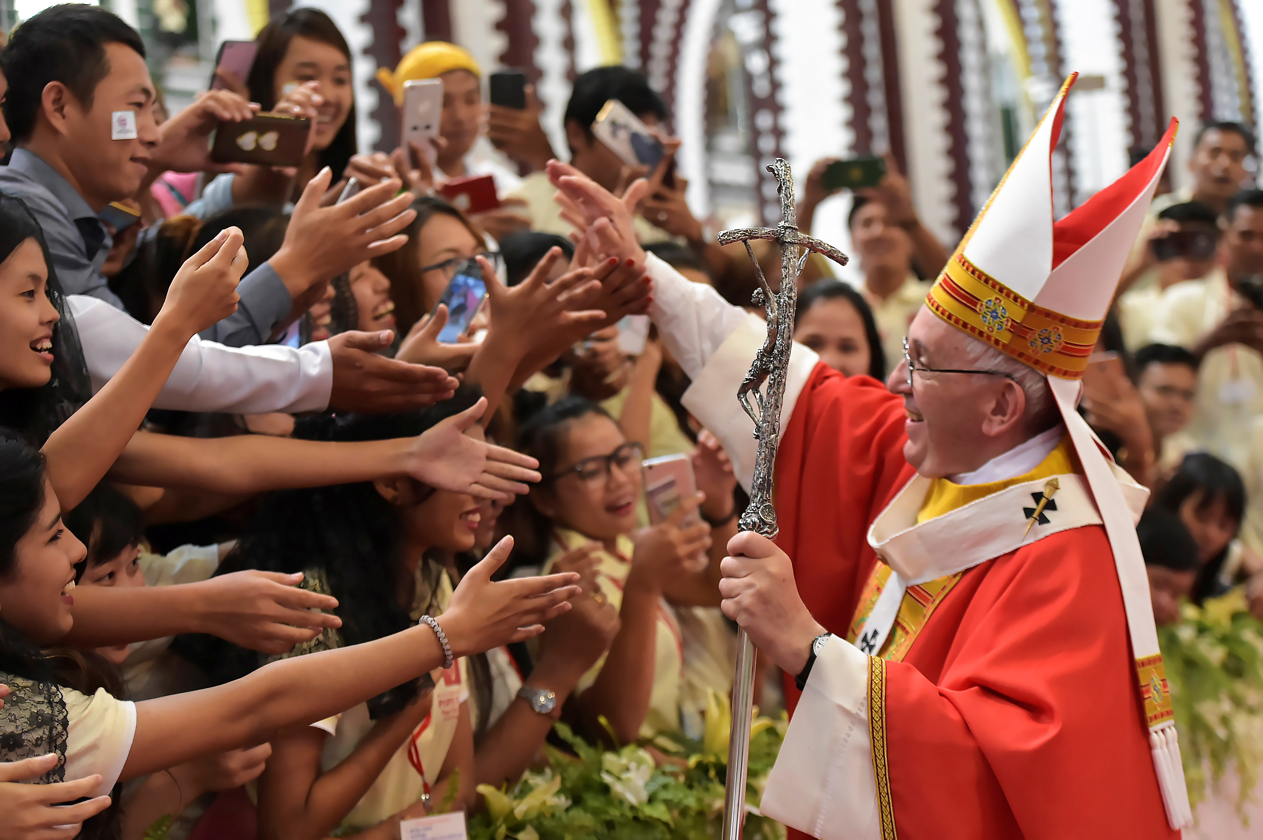 Pope Francis greets young people after celebrating Mass with youths Nov. 30 at St. Mary's Cathedral in Yangon, Myanmar. Foreign trips, a focus on the rights and needs of migrants and refugees and a Synod of Bishops dedicated to young people all are on the 2018 calendar for Pope Francis. (CNS photo/L'Osservatore Romano via Reuters) See VATICAN-LETTER-POPE-2018 Dec. 20, 2017.