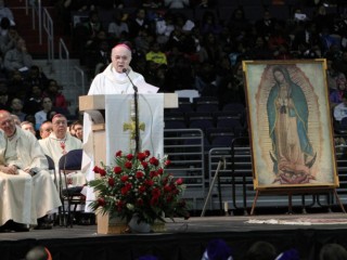 An image of Our Lady of Guadalupe is seen as Archbishop Carlo Maria Vigano, apostolic nuncio to the U.S., delivers a message from Pope Francis during a pro-life youth Mass at the Verizon Center in Washington Jan. 22. Thousands of young people gathered at the arena to rally and pray before participating in the annual March for Life. (CNS photo/Gregory A. Shemitz) See YOUTH-VERIZON Jan. 23, 2015.