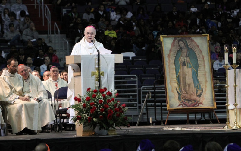 An image of Our Lady of Guadalupe is seen as Archbishop Carlo Maria Vigano, apostolic nuncio to the U.S., delivers a message from Pope Francis during a pro-life youth Mass at the Verizon Center in Washington Jan. 22. Thousands of young people gathered at the arena to rally and pray before participating in the annual March for Life. (CNS photo/Gregory A. Shemitz) See YOUTH-VERIZON Jan. 23, 2015.