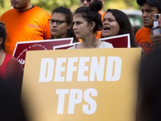 A woman holds a sign showing her support for Temporary Protected Status, or TPS, during a 2017 rally near the U.S. Capitol in Washington. (CNS photo/Tyler Orsburn) See TPS-BISHOP-CHILDREN Jan. 4, 2018.