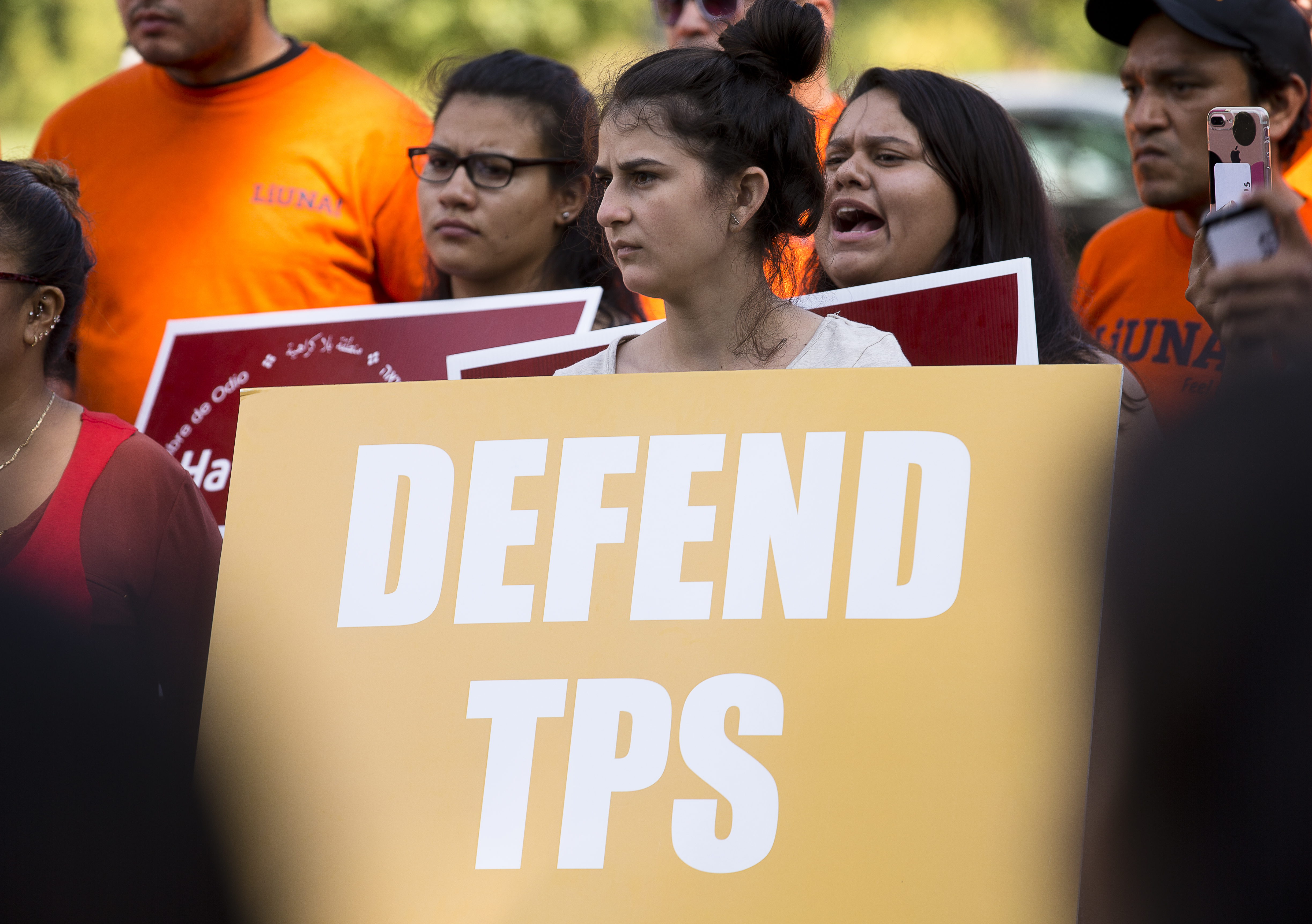 A woman holds a sign showing her support for Temporary Protected Status, or TPS, during a 2017 rally near the U.S. Capitol in Washington. (CNS photo/Tyler Orsburn) See TPS-BISHOP-CHILDREN Jan. 4, 2018.