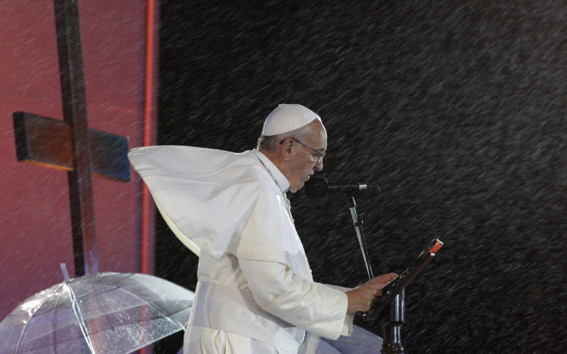 Rain falls as Pope Francis speaks during the World Youth Day welcome ceremony on Copacabana beach in Rio de Janeiro in this July 25, 2013, file photo. The pope hasn't been afraid to brave the elements during his numerous outdoor events. (CNS photo/Paul Haring) See POPE-FIFTH-ANNIVERSARY Feb. 13, 2018.