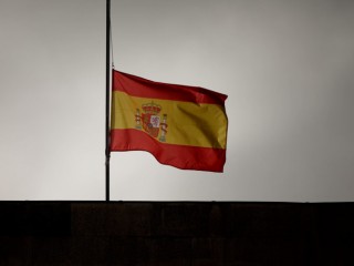 SANTIAGO DE COMPOSTELA, SPAIN - JULY 28:  A Spanish flag flies at half mast on top of Santiago First Court building while preliminar judge Luis Alaez is asking for declaration to Jose Garzon Amo, Santiago high speed train crash driver, on July 28, 2013 in Santiago de Compostela, Spain.  The high speed train crashed after it derailed on a bend as it approached the north-western Spanish city of Santiago de Compostela at 8:40pm on July 24th. At least 78 people have died and a further 131 are reported injured. The crash occurred on the eve of the Santiago de Compostela Festivities. The train driver, Garzon Amo, has been formally accused of reckless homicide and remains in custody awaiting an appearance in court.  (Photo by Gonzalo Arroyo/Getty Images)