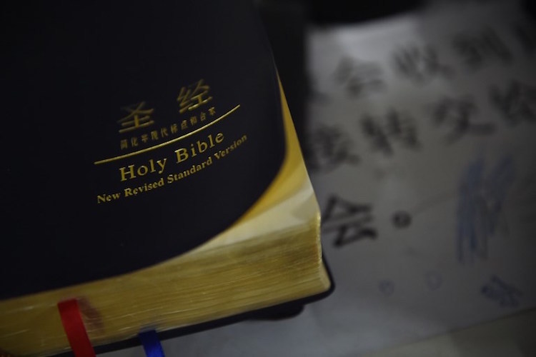 A Bible is seen after an underground church Christmas Eve service at an apartment in Beijing on December 24, 2014. Members of underground Chinese Christian churches celebrated Christmas Eve in private ceremonies, while those in churches officially sanctioned by the communist government attended more open ceremonies. AFP PHOTO / Greg BAKER / AFP PHOTO / GREG BAKER