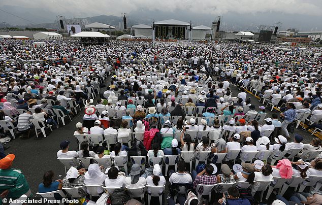 People attend a Mass celebrated by Pope Francis in Medellin, Colombia, Saturday, Sept. 9, 2017. (AP Photo/Fernando Vergara)