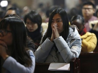People pray during Mass in 2016 at the Cathedral of the Immaculate Conception in Beijing. A senior Vatican official has hinted there is an unofficial agreement between the Holy See and Beijing on the appointment of bishops, even as negotiations to formalize arrangements continue to hit roadblocks. (CNS photo/Wu Hong, EPA) See VATICAN-CHINA-INFORMAL-BISHOPS Aug. 9, 2017.