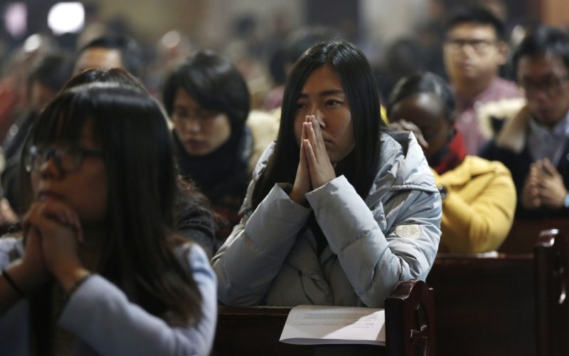 People pray during Mass in 2016 at the Cathedral of the Immaculate Conception in Beijing. A senior Vatican official has hinted there is an unofficial agreement between the Holy See and Beijing on the appointment of bishops, even as negotiations to formalize arrangements continue to hit roadblocks. (CNS photo/Wu Hong, EPA) See VATICAN-CHINA-INFORMAL-BISHOPS Aug. 9, 2017.