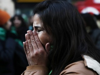 A woman in Buenos Aires, Argentina, reacts June 14  after hearing that the nation's lower house approved a bill to legalize abortion in the first 14 weeks of pregnancy. (CNS photo/David Fernandez, EPA) See ARGENTINA-ABORTION-REACT June 14, 2018.