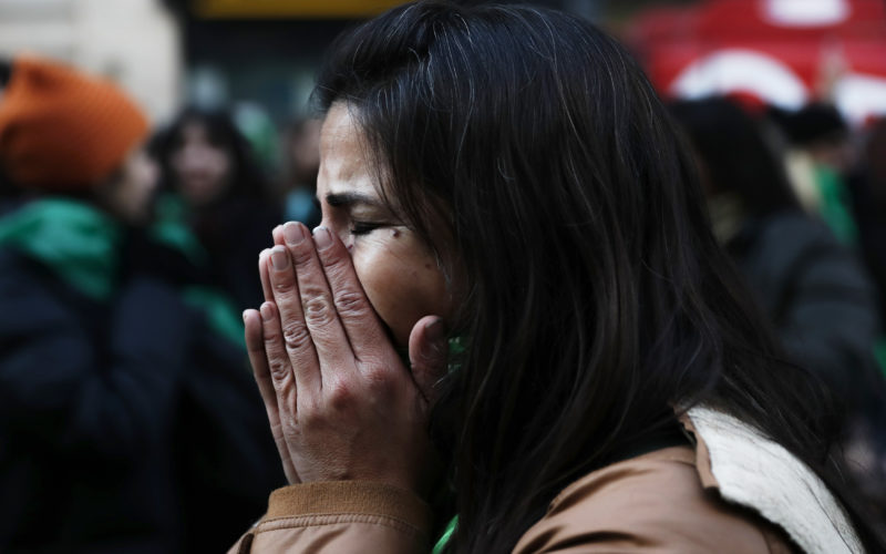 A woman in Buenos Aires, Argentina, reacts June 14  after hearing that the nation's lower house approved a bill to legalize abortion in the first 14 weeks of pregnancy. (CNS photo/David Fernandez, EPA) See ARGENTINA-ABORTION-REACT June 14, 2018.