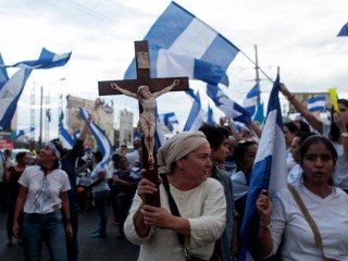 A demonstrator holds a crucifix during a protest against Nicaraguan President Daniel Ortega's government in Managua, Nicaragua, May 15. (CNS photo/Oswaldo Rivas, Reuters) See NICARAGUA-MEDIATE-CHURCH May 17, 2018.