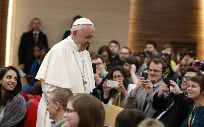 Pope Francis prepares to take a photo with young people at a presynod gathering of youth delegates in Rome March 19. The Vatican has released the working document for the October Synod of Bishops on young people, the faith and vocational discernment. (CNS photo/Paul Haring) See SYNOD-YOUTH-DOCUMENT June 19, 2018.