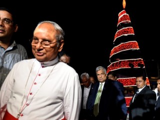 Sri Lankan Prime Minister Ranil Wickremesinghe (C) and Sri Lankan Cardinal Malcom Ranjith (2L) walk with officials as they attend the  Grow with every season lighting of a Christmas Tree at The Arcade Independence Square in Colombo on December 20, 2016. 
Christians account for some six percent of Sri Lanka's 21 million people. / AFP / Ishara S. KODIKARA        (Photo credit should read ISHARA S. KODIKARA/AFP/Getty Images)