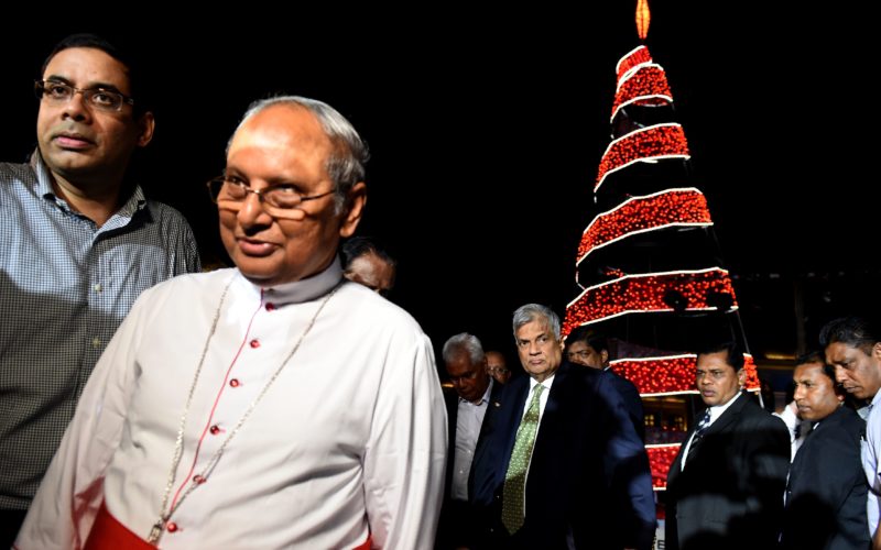 Sri Lankan Prime Minister Ranil Wickremesinghe (C) and Sri Lankan Cardinal Malcom Ranjith (2L) walk with officials as they attend the  Grow with every season lighting of a Christmas Tree at The Arcade Independence Square in Colombo on December 20, 2016.  Christians account for some six percent of Sri Lanka's 21 million people. / AFP / Ishara S. KODIKARA        (Photo credit should read ISHARA S. KODIKARA/AFP/Getty Images)