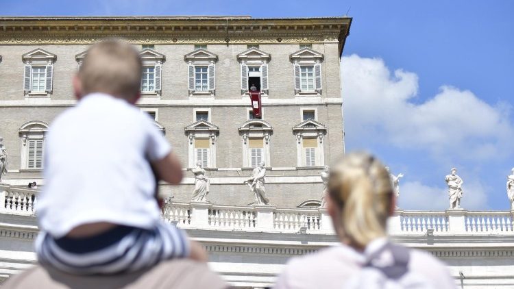 Pope Francis waves to the crowds at the Sunday Angelus 1