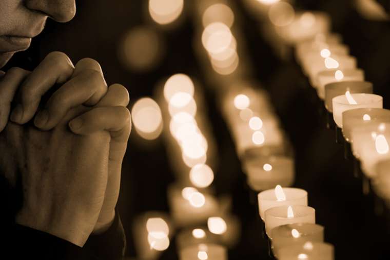 Praying_Credit_Andrey_Kuzmin_Shutterstock_NCA