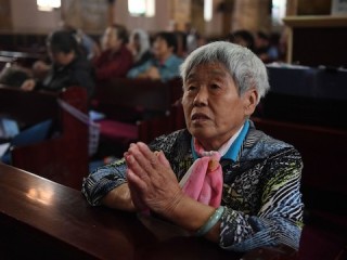 A Catholic worshipper attends a mass at the government-sanctioned South Cathedral in Beijing on September 27, 2018. - Pope Francis called on September 26 for all Chinese Catholics to reconcile, while admitting that a historic deal with Beijing on nominating bishops may have caused "confusion". (Photo by Greg Baker / AFP)