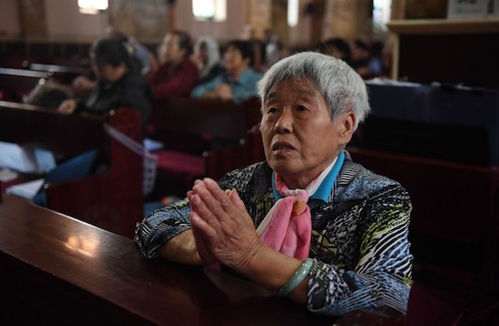 A Catholic worshipper attends a mass at the government-sanctioned South Cathedral in Beijing on September 27, 2018. - Pope Francis called on September 26 for all Chinese Catholics to reconcile, while admitting that a historic deal with Beijing on nominating bishops may have caused "confusion". (Photo by Greg Baker / AFP)