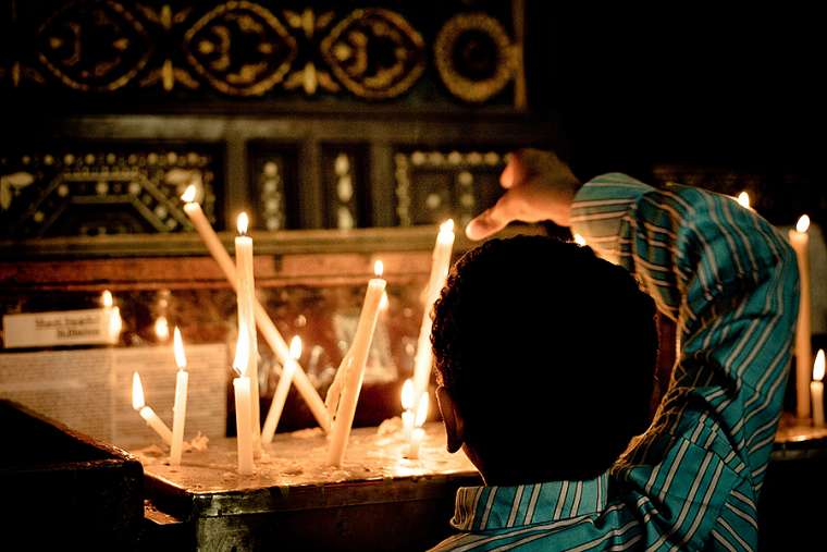 Coptic_Christian_boy_lights_a_candle_at_a_church_in_Cairo_Credit_Christopher_Rose_via_Flickr_CC_BY_NC_20_CNA