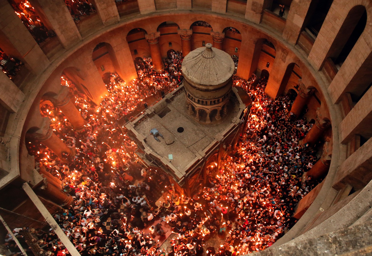 TOPSHOT - Christian Orthodox worshippers hold up candles lit from the "Holy Fire" as thousands gather in the Church of the Holy Sepulchre in Jerusalem's Old City, on April 30, 2016, during the Orthodox Easter ceremonies. The ceremony celebrated in the same way for eleven centuries, is marked by the appearance of "sacred fire" in the two cavities on either side of the Holy Sepulchre. / AFP / THOMAS COEX (Photo credit should read THOMAS COEX/AFP/Getty Images)