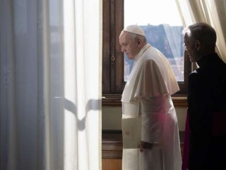 Pope_Francis_looks_out_a_window_of_the_apostolic_palace_March_18_2020_Credit_Vatican_Media