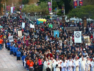 Attendees look on during a Catholic March in Sydney on Sunday, June 3, 2018. Archbishop of Sydney Anthony Fisher OP led thousands of Catholics from across Sydney on a march through CBD Sydney as a sign of faith in Jesus. 2018 marks the 200th Anniversary of Eucharistic Adoration in Australia and will be celebrated with the Walk With Christ Eucharistic Procession. (AAP Image/Jeremy Ng)