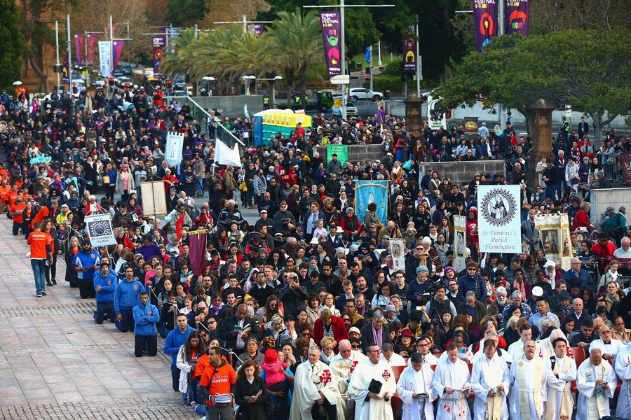 Attendees look on during a Catholic March in Sydney on Sunday, June 3, 2018. Archbishop of Sydney Anthony Fisher OP led thousands of Catholics from across Sydney on a march through CBD Sydney as a sign of faith in Jesus. 2018 marks the 200th Anniversary of Eucharistic Adoration in Australia and will be celebrated with the Walk With Christ Eucharistic Procession. (AAP Image/Jeremy Ng)